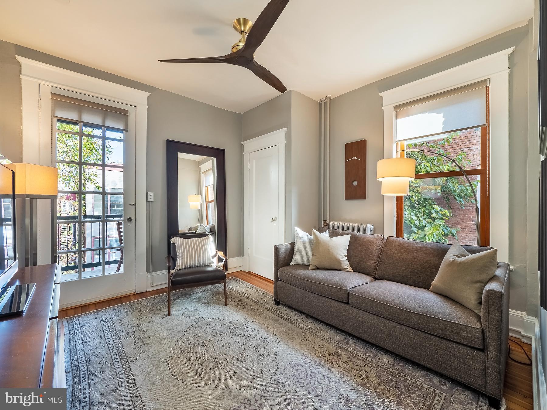 1736 Columbia Road Northwest, Unit 309 Washington, DC 20009 - Photo 20 of 38 a living room with furniture and a window