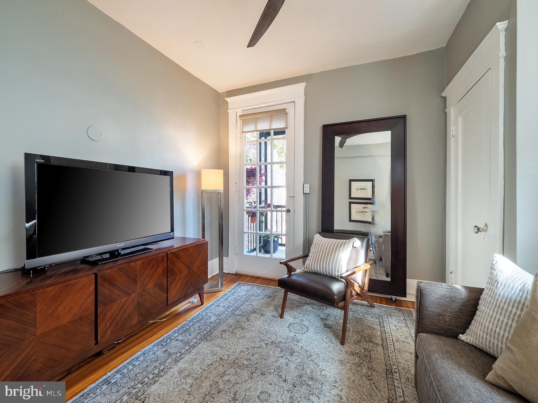 1736 Columbia Road Northwest, Unit 309 Washington, DC 20009 - Photo 21 of 38 a living room with furniture and a flat screen tv