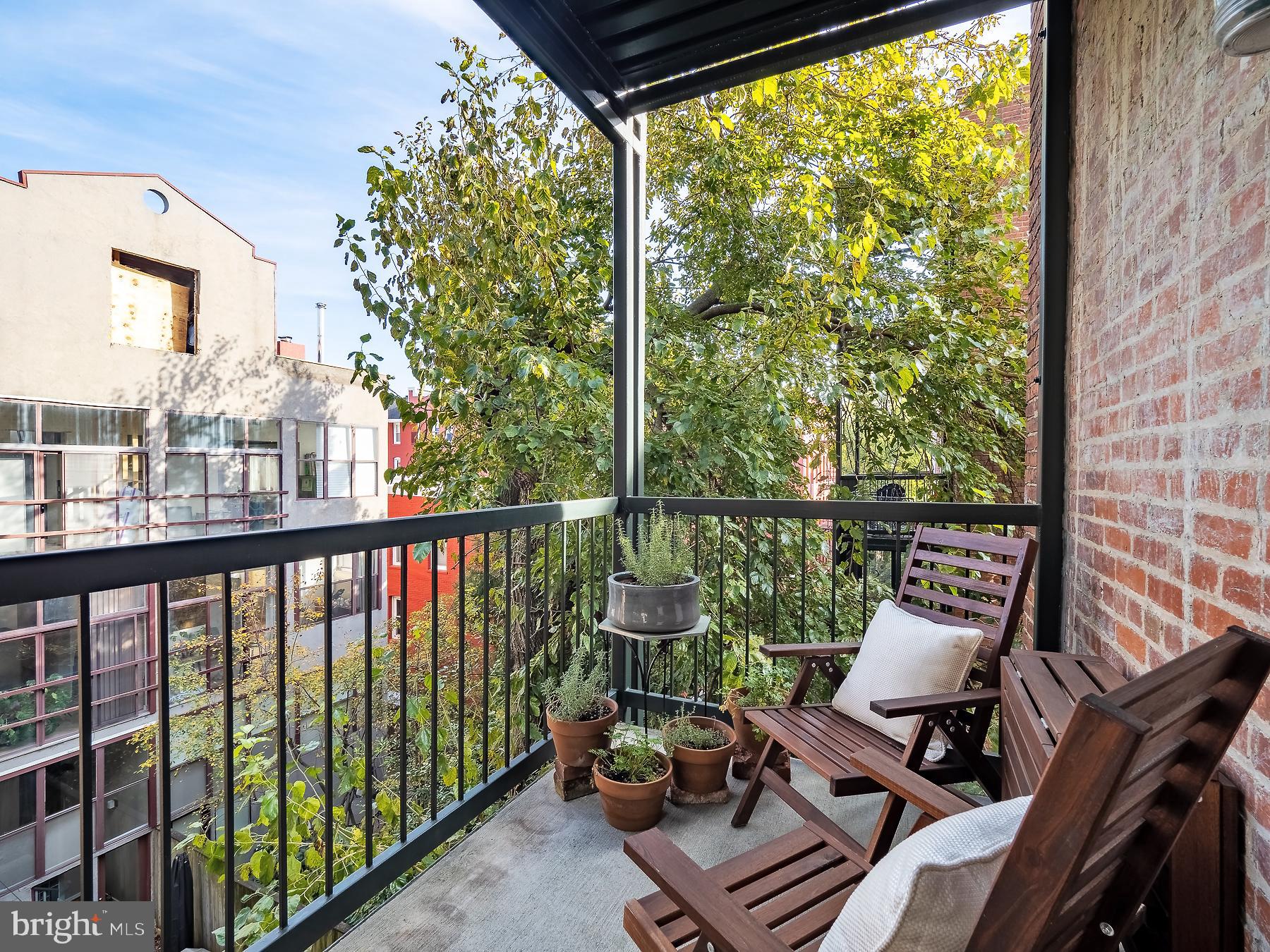 1736 Columbia Road Northwest, Unit 309 Washington, DC 20009 - Photo 22 of 38 a view of a chair and tables in the balcony