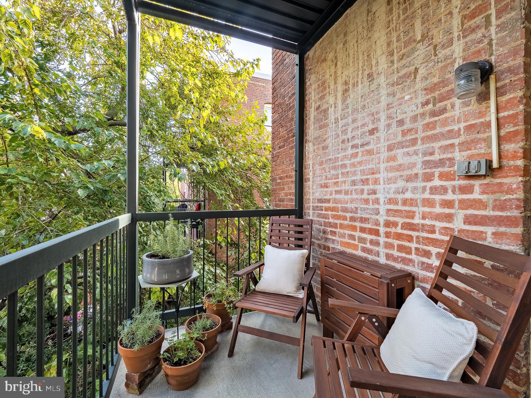 1736 Columbia Road Northwest, Unit 309 Washington, DC 20009 - Photo 23 of 38 a view of a chair and tables in the balcony