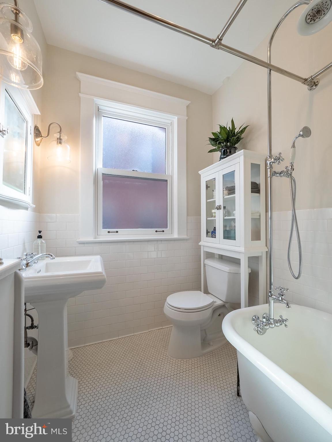 1736 Columbia Road Northwest, Unit 309 Washington, DC 20009 - Photo 24 of 38 a bathroom with a sink a toilet and shower