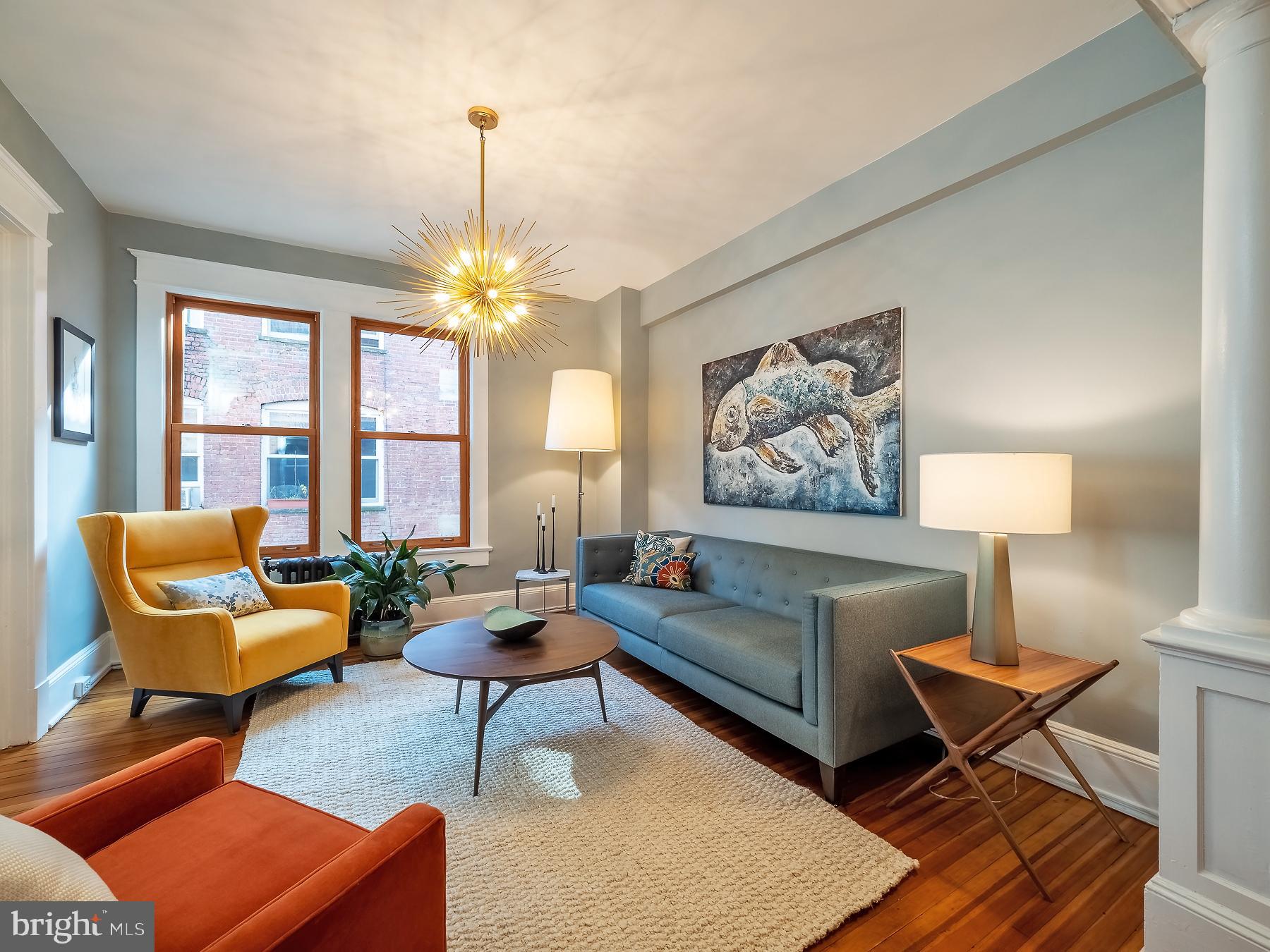 1736 Columbia Road Northwest, Unit 309 Washington, DC 20009 - Photo 8 of 38 a living room with furniture a chandelier and a window