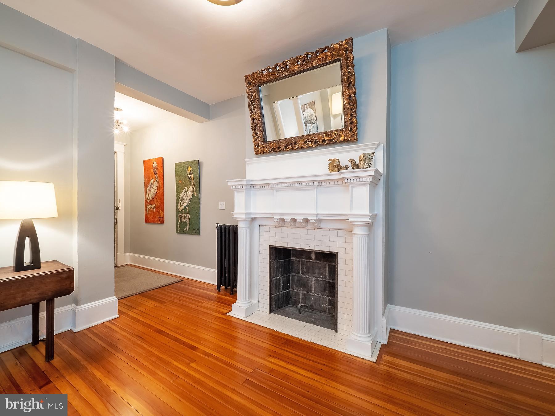 1736 Columbia Road Northwest, Unit 309 Washington, DC 20009 - Photo 10 of 38 a view of a livingroom with an empty space and a fireplace