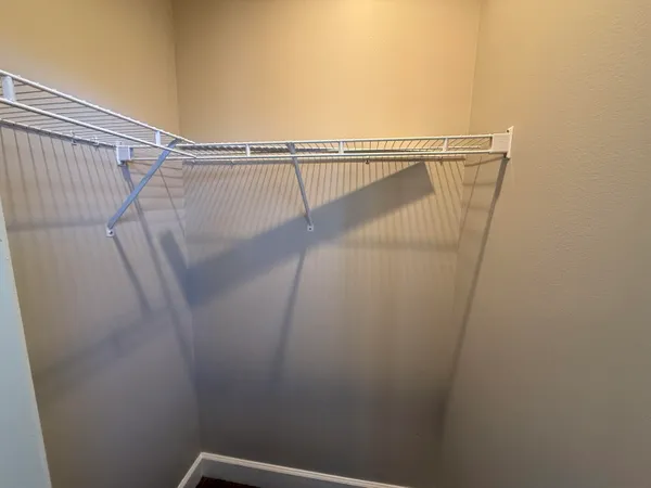 a view of walk in closet with clothes