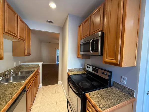 a kitchen with granite countertop cabinets and steel stainless steel appliances