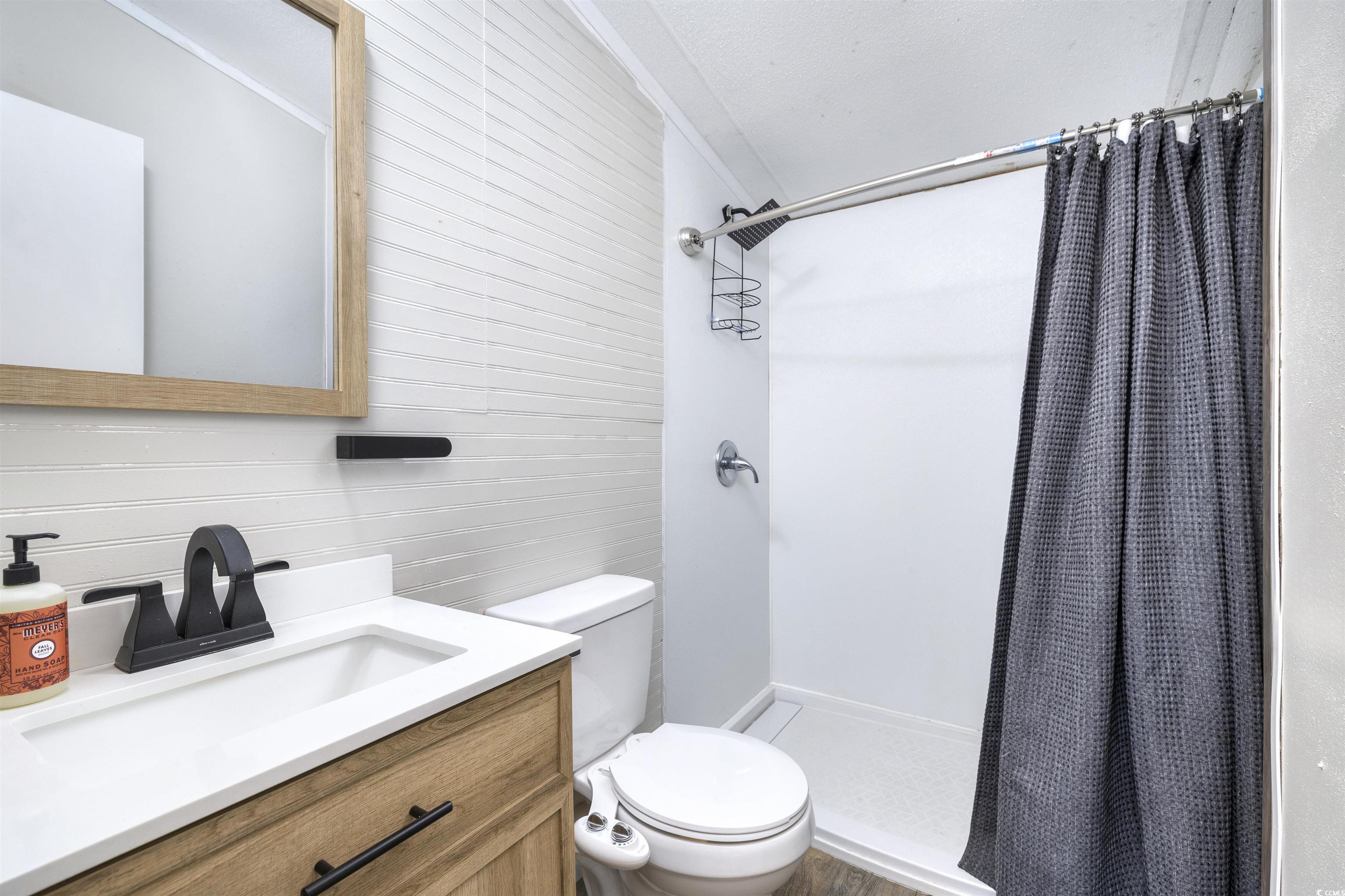 5764 Thompson Road Nichols, SC 29581 - Photo 12 of 35 Bathroom with a stall shower, toilet, and vanity