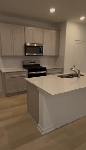 a kitchen with granite countertop a sink and cabinets