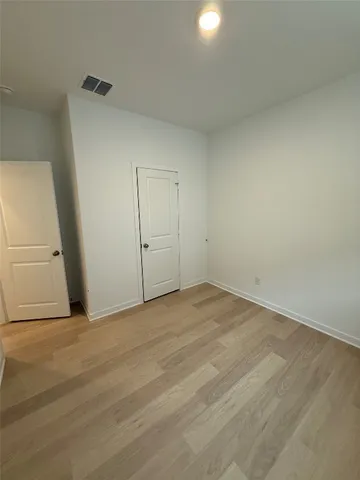 an empty room with wooden floor