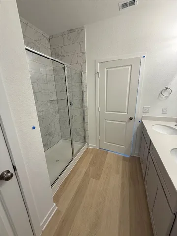 a bathroom with a shower and a sink