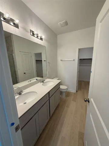 a bathroom with a double vanity sink and mirror