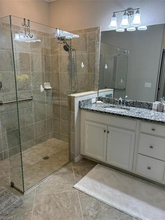 1599 Marton Court Naples, FL 34113 - Photo 10 of 22 a bathroom with a shower sink and mirror