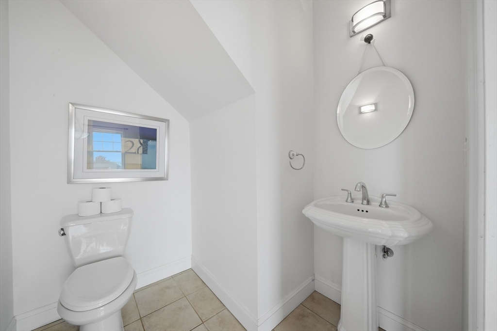 233 Beach Road, Unit A11 Salisbury, MA 01952 - Photo 14 of 37 a bathroom with a toilet a sink and mirror