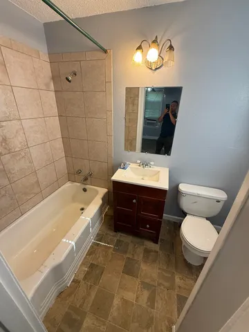 a bathroom with a sink a toilet and bathtub