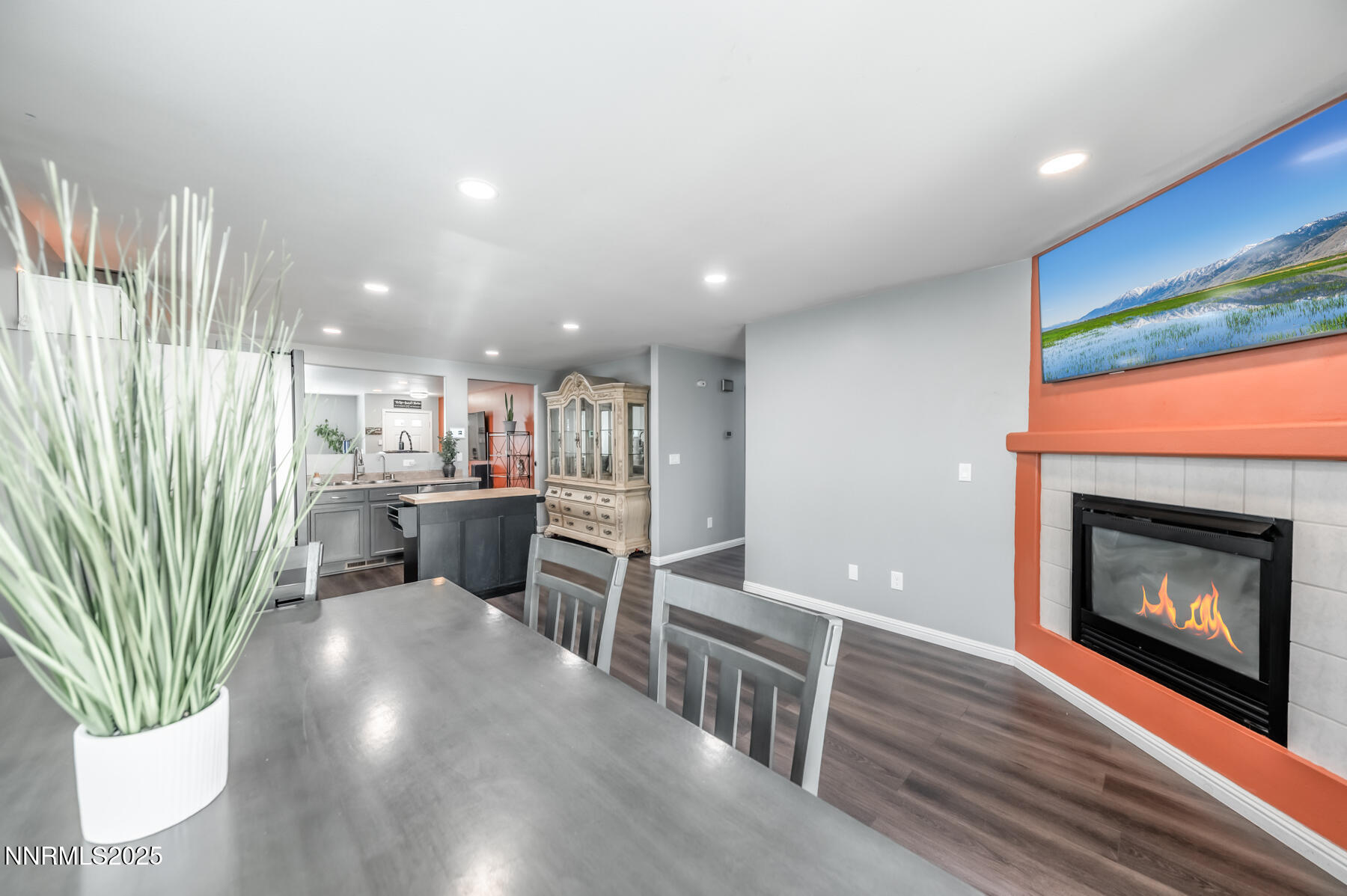 7447 Findhorn Drive Reno, NV 89506 - Photo 12 of 27 a living room with stainless steel appliances furniture a fireplace a rug and a large window
