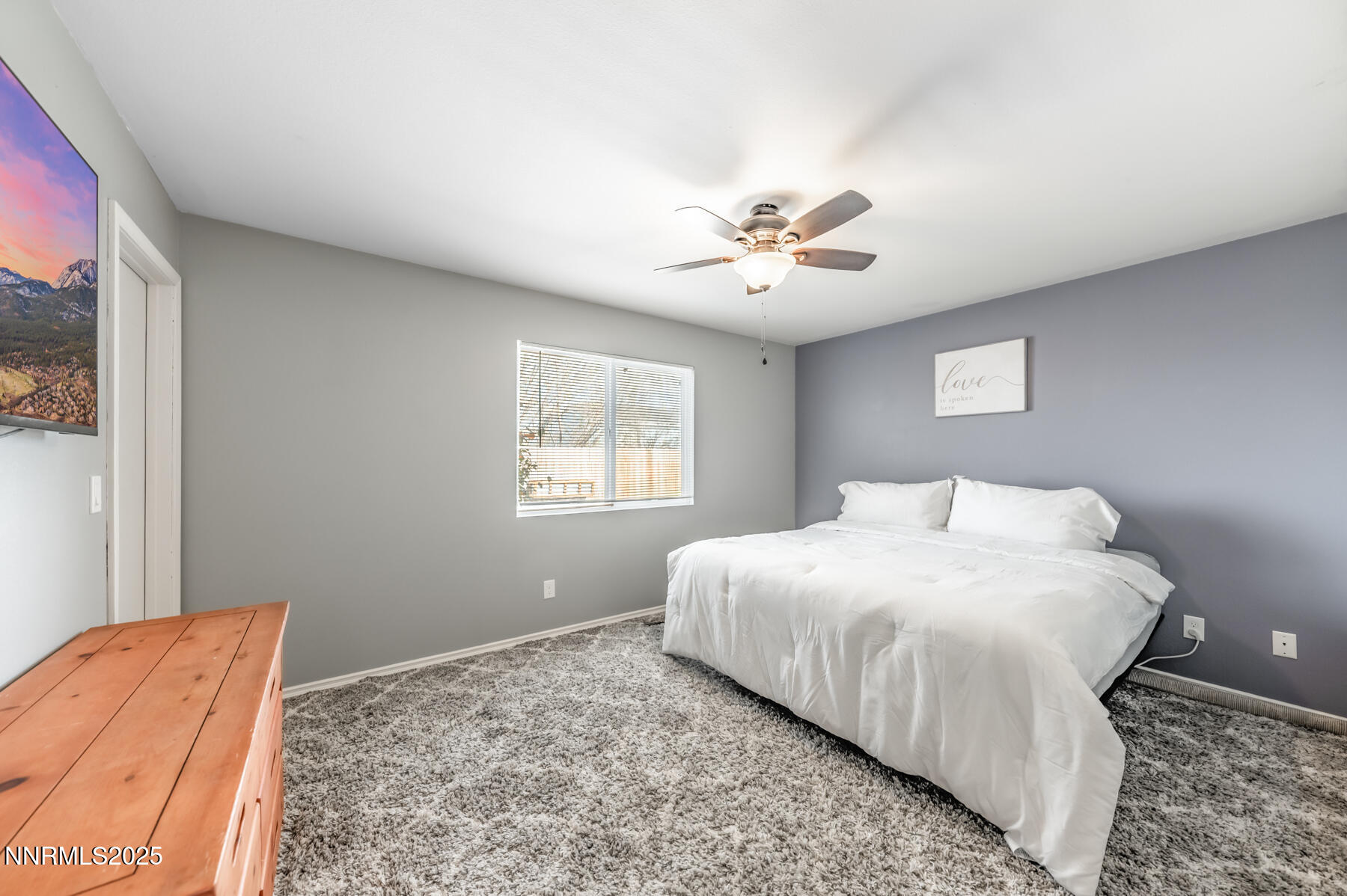 7447 Findhorn Drive Reno, NV 89506 - Photo 13 of 27 a bedroom with a large bed and a window