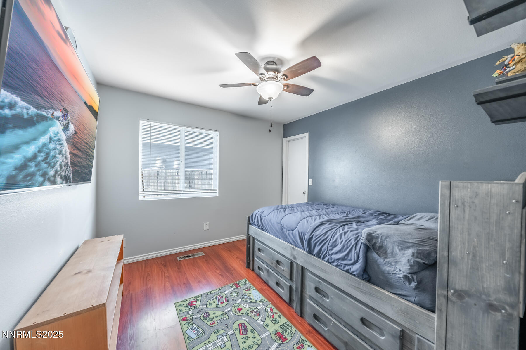 7447 Findhorn Drive Reno, NV 89506 - Photo 15 of 27 a bedroom with a bed and a chandelier