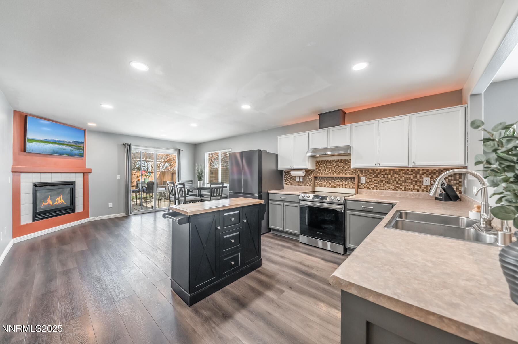 7447 Findhorn Drive Reno, NV 89506 - Photo 8 of 27 a large kitchen with granite countertop a stove top oven sink and cabinets