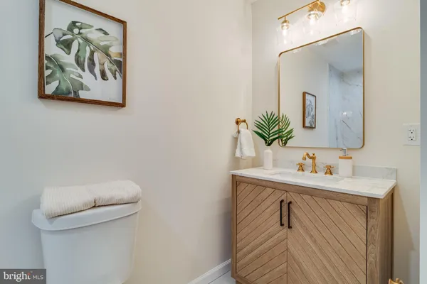 a bathroom with a sink a toilet and mirror