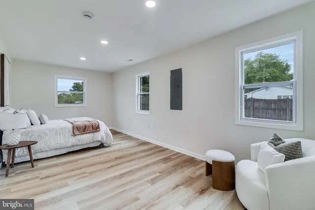 a bedroom with furniture and wooden floor