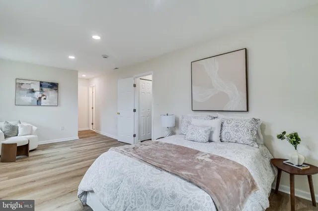 a bedroom with a bed and a painting on the wall