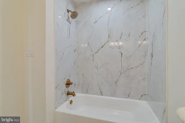 a bathroom with a sink a bathtub and shower