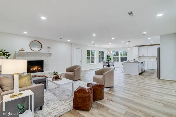 a living room with fireplace furniture and a wooden floor