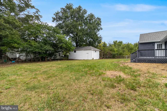 a white house that has a tree in front of it