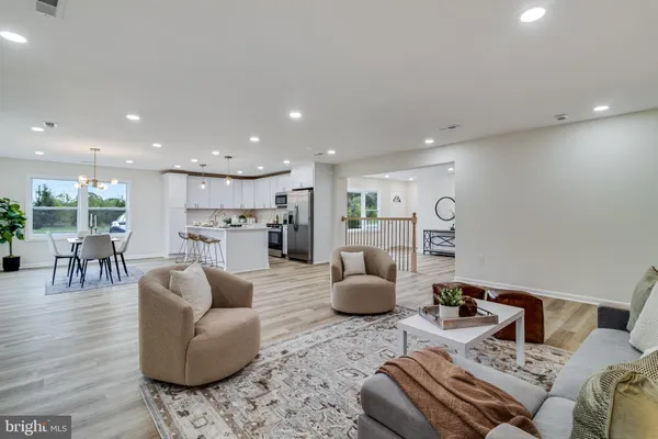 a living room with furniture and kitchen view