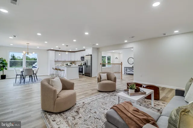 a living room with furniture and kitchen view