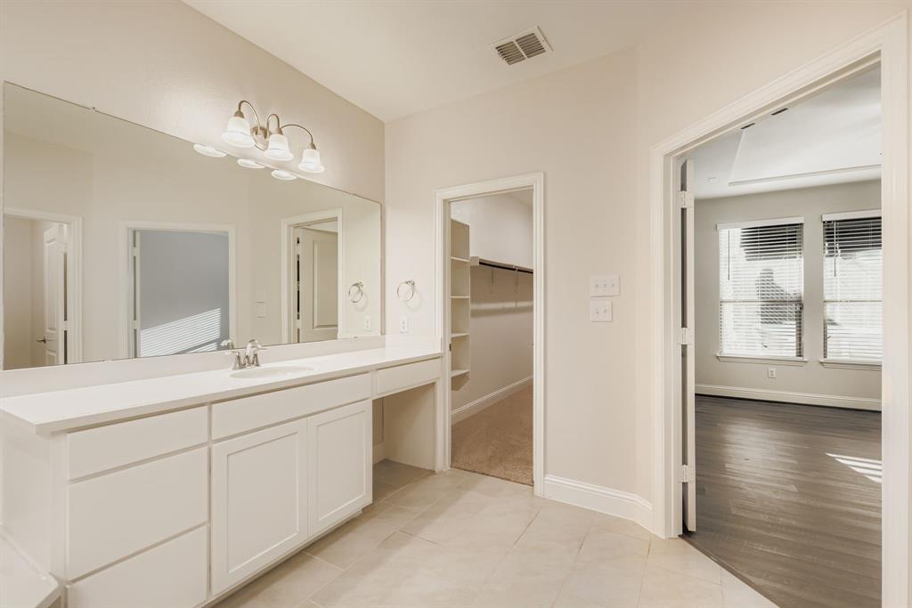 312 Magnolia Drive Oak Point, TX 75068 - Photo 15 of 28 Bathroom with vanity, light tile patterned flooring, a spacious closet, and a chandelier