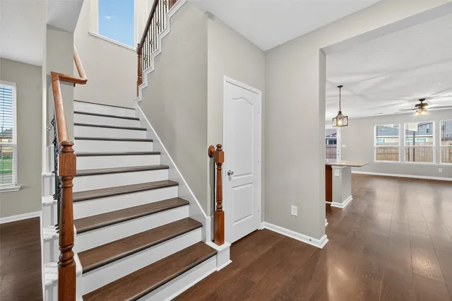 a view of entryway with wooden floor and front door