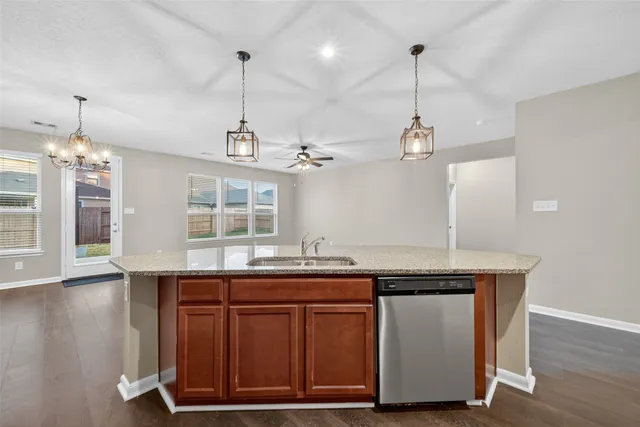 a kitchen with kitchen island a wooden floor and a chandelier