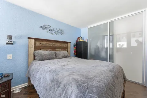 a large bed sitting in a bedroom next to a cabinet