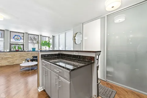 a kitchen with stainless steel appliances granite countertop a stove and a sink
