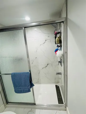a bathroom with a toilet and a shower