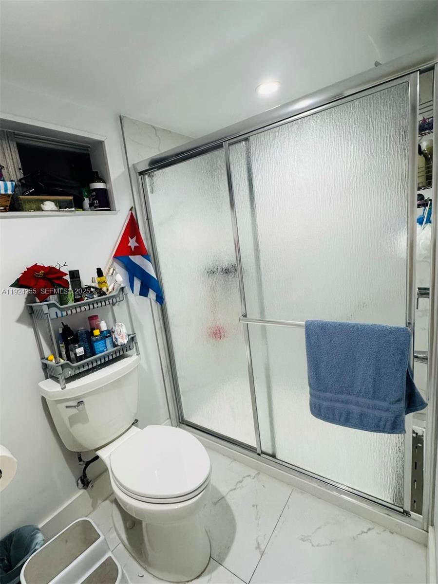 6831 Southwest 2nd Street, Unit FRONT Miami, FL 33144 - Photo 6 of 8 a bathroom with a toilet and a shower