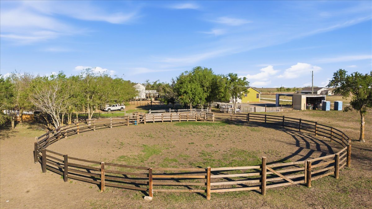 17309 Skog Road Elgin, TX 78621 - Photo 6 of 17 View of yard featuring an enclosed horse arena and an outbuilding