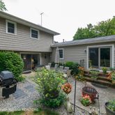 a front view of a house with a yard and outdoor seating