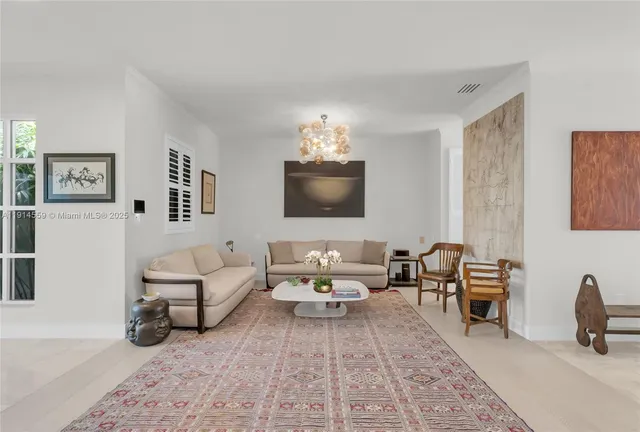 a living room with granite countertop couches a coffee table and large window with wooden floor