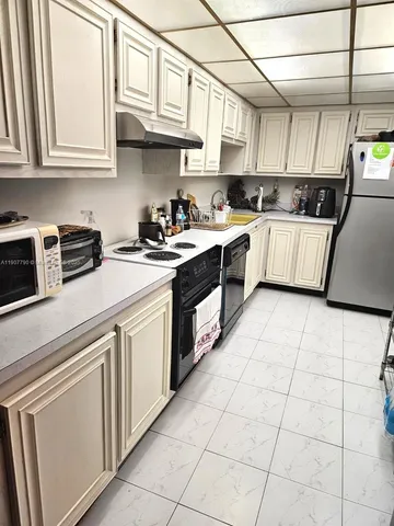 a kitchen with stainless steel appliances granite countertop a stove sink and cabinets