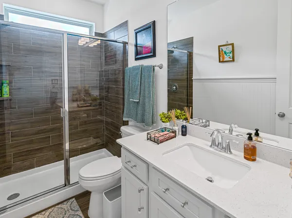 a bathroom with a sink toilet and shower