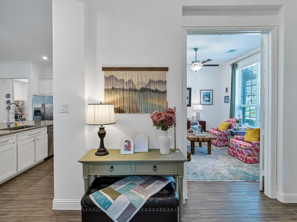 a spacious bedroom with a bed a couch and a large window