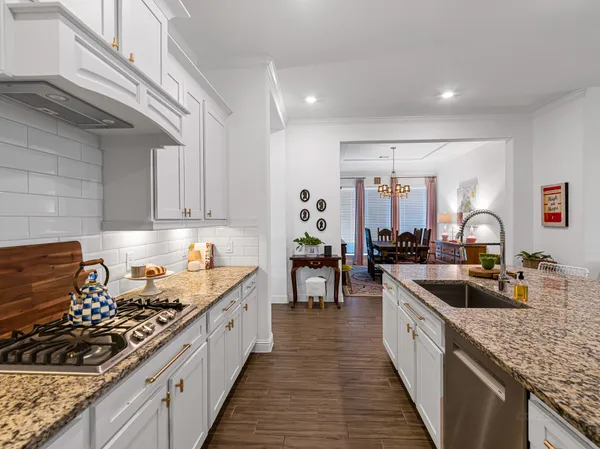 a bathroom with a granite countertop sink and a mirror or bathtub