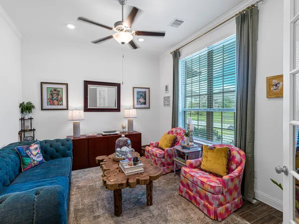 a living room with furniture and wooden floor