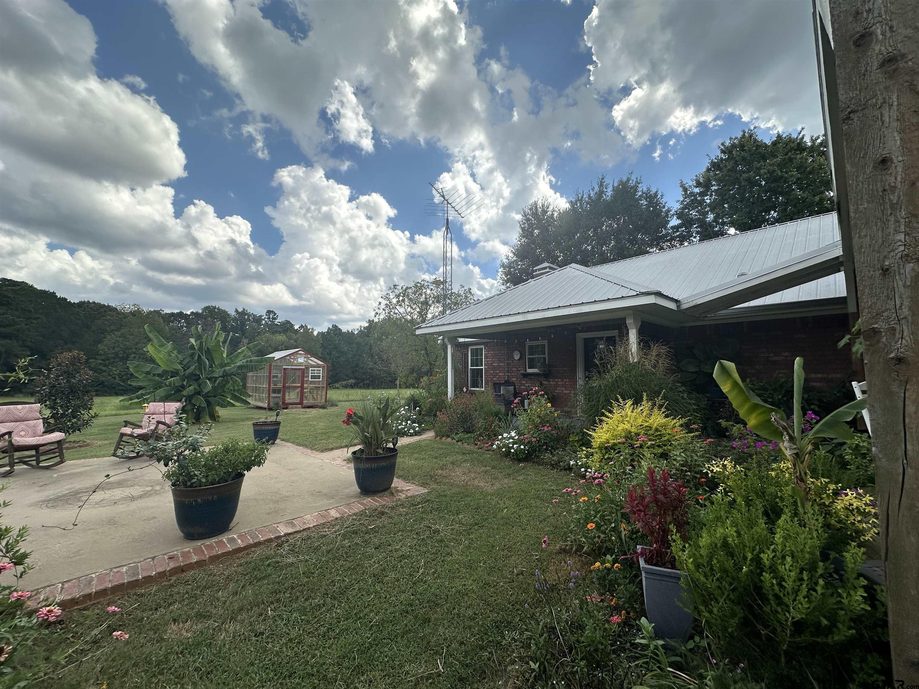 2281 Fm 241s Rusk, TX 75785 - Photo 19 of 31 a front view of a house with a yard and a garden