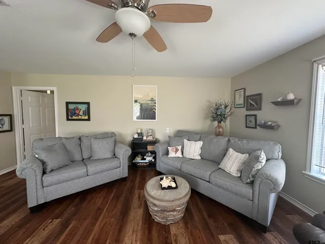 a bedroom with a bed wooden floor and a flat screen tv