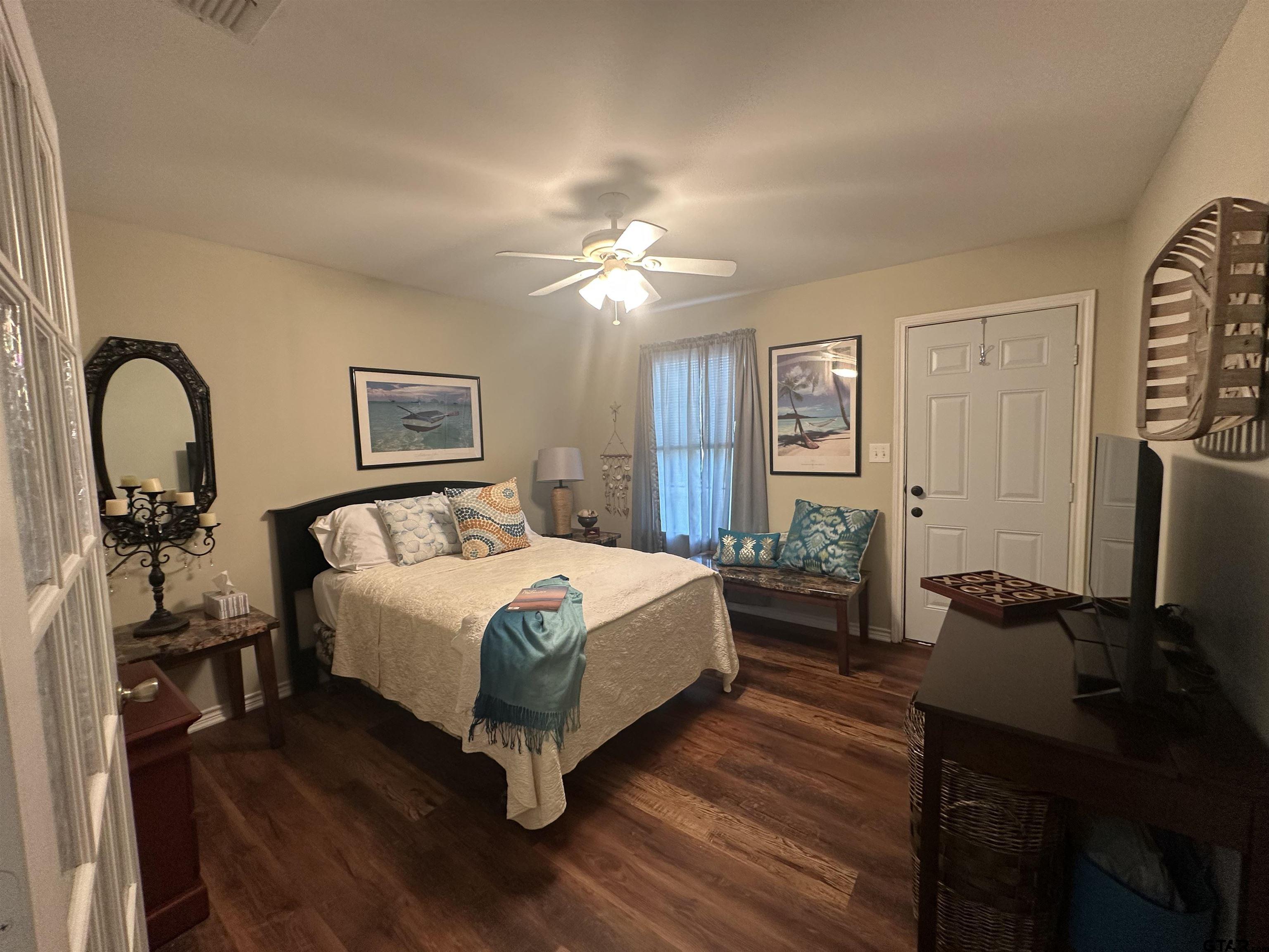 2281 Fm 241s Rusk, TX 75785 - Photo 27 of 31 a bedroom with a bed wooden floor and a flat screen tv