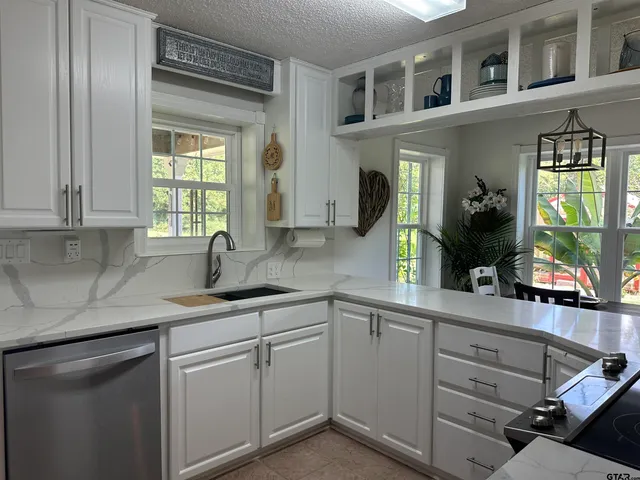 a bed sitting in a bedroom next to a cabinet