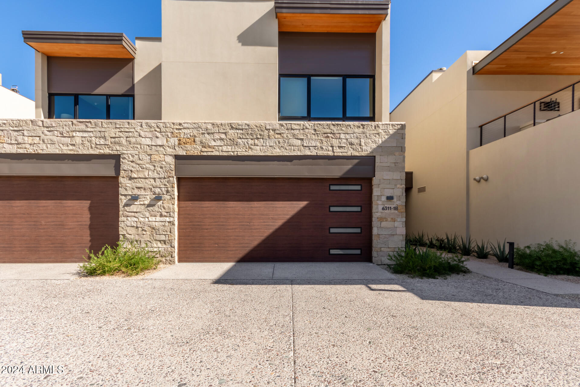 6311 East Phoenician Boulevard, Unit 18 Scottsdale, AZ 85251 - Photo 1 of 45 a front view of a house with a yard and garage