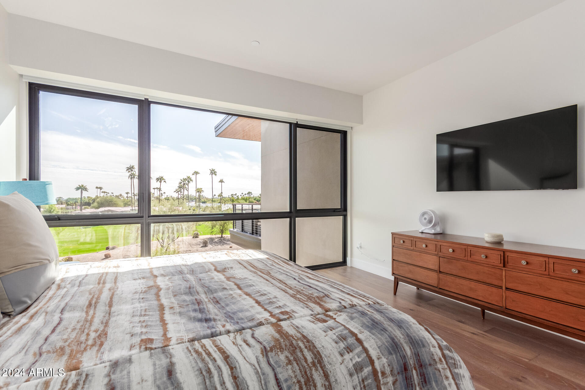 6311 East Phoenician Boulevard, Unit 18 Scottsdale, AZ 85251 - Photo 16 of 45 a bedroom with a bed and a flat screen tv
